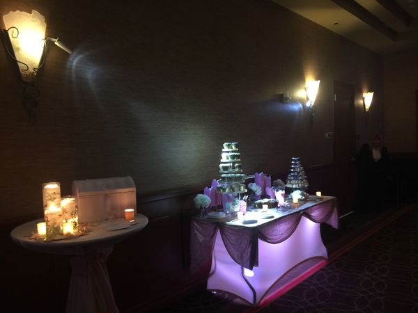 Pin Spots on the dessert table and uplighting beneath the table.
