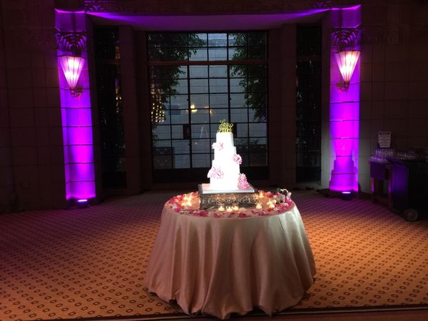 Purple uplighting to frame the cake. Pin Spots on the cake.