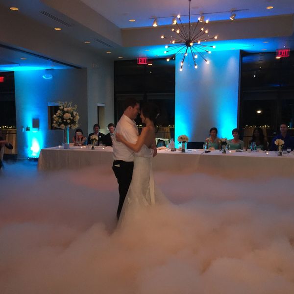 Soft romantic uplighting while Dancing on a Cloud machine fills the dance floor during a first dance
