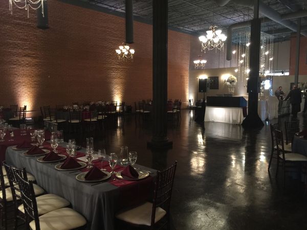 White decorative uplighting around the room and under DJ table.