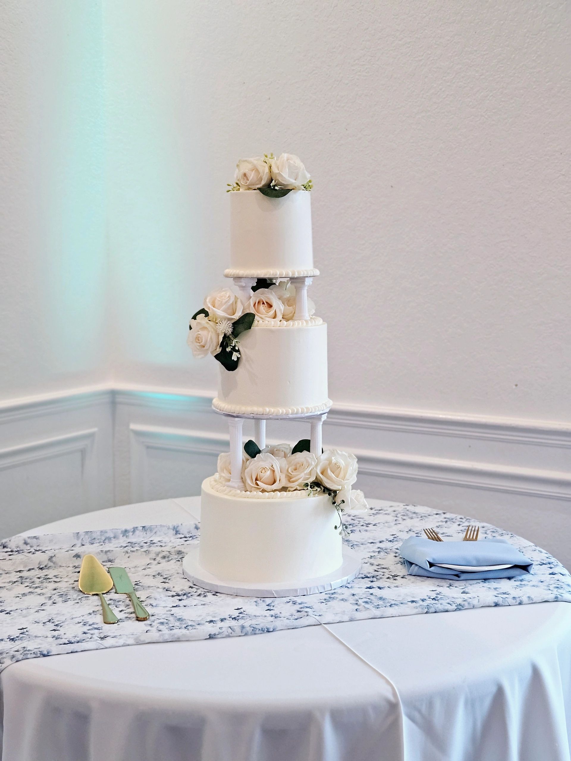 White tiered wedding cake with floral decorations