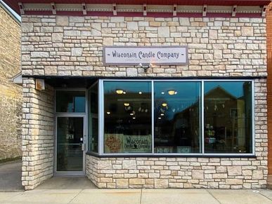 Exterior of Wisconsin Candle Company with stone facade and large windows.
