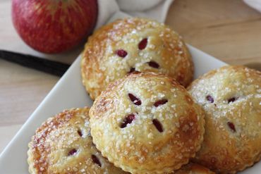 These raspberry mini pies were made by All About the Cake.