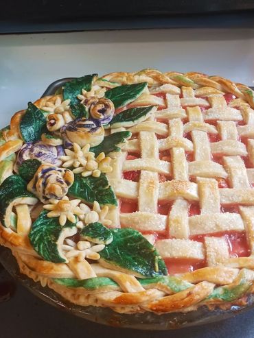 This 10" Strawberry Rhubarb Pie with holiday decor was made by All About the Cake.