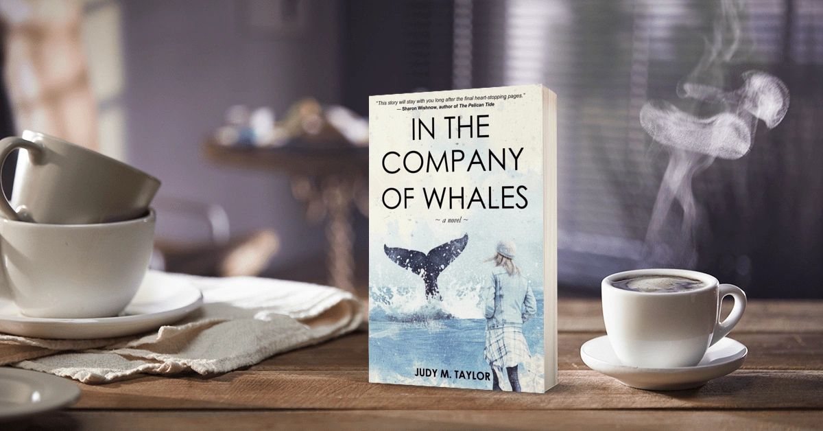 A cozy scene with a book titled 'In the Company of Whales' and a steaming cup of coffee.