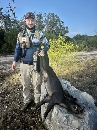 Hunter holding hog
