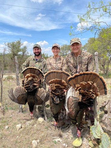 3 hunters showing 3 turkeys taken