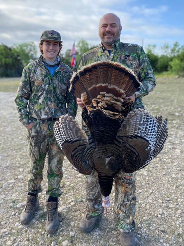 Father and son with turkey harvest