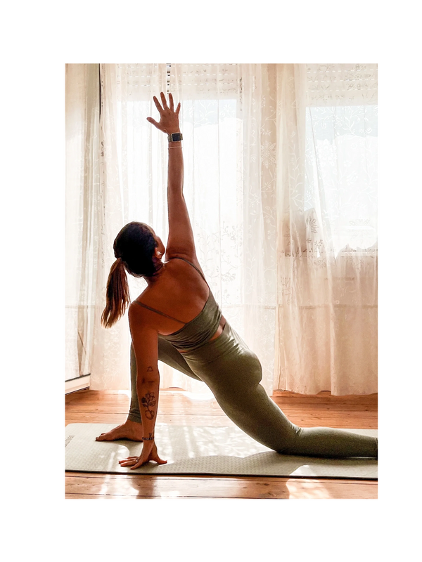 woman doing yoga pose with apple watch and tattoos
