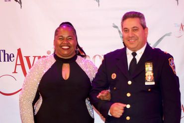 Amelia Patrice one of the Honorees escorted by Inspector Hernandez of the 47 Precinct