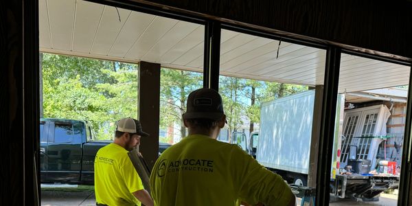 Expert installer replacing damaged door frame with new, secure material for improved curb appeal.