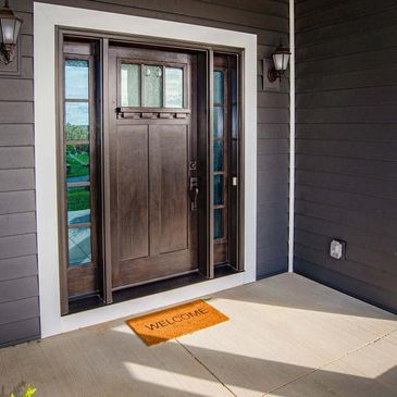 Close-up of a stylish wooden entry door. With or without glass, transoms, sidelites, French doors.