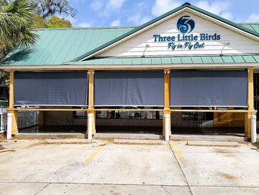 Exterior vertical roller shades.