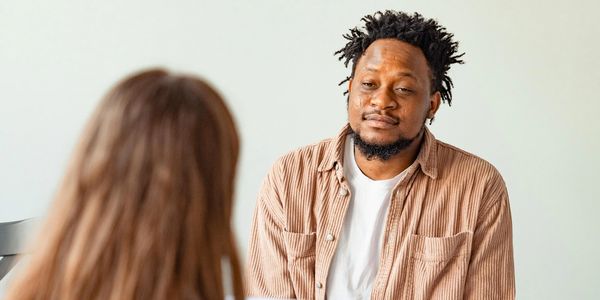 Man attentively listening to a woman during a conversation.