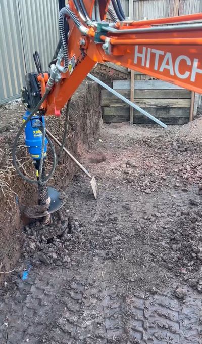 Auger attachment on excavator.