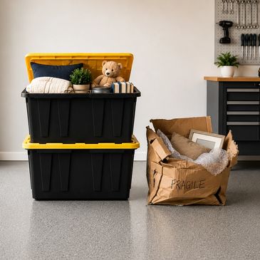 Stacked storage bins and a fragile box packed with household items.