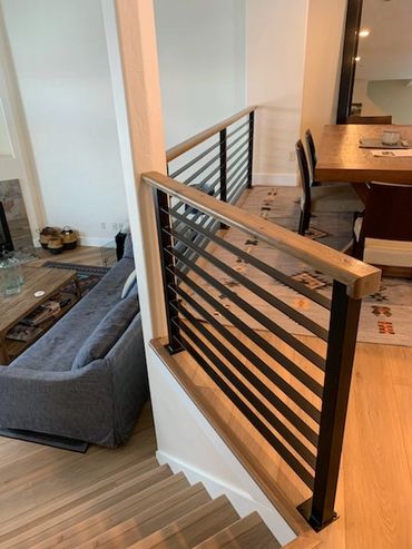 Steel railing with wooden topper, stained to match new floor