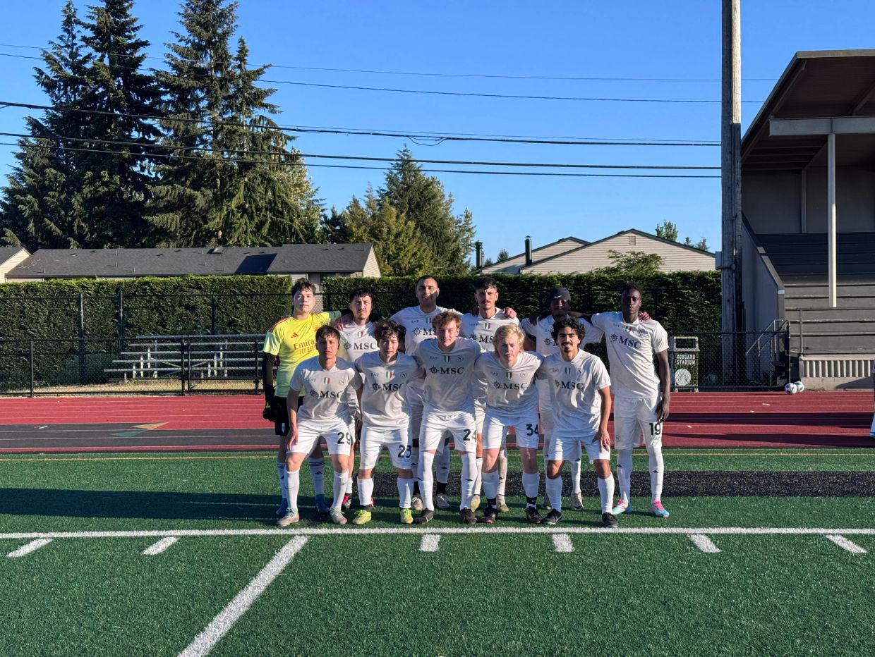 Soccer team posing on the field.