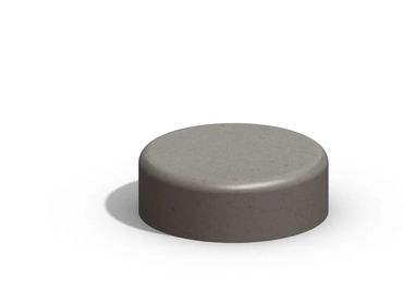 A concrete bench casting a shadow on a white surface.