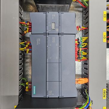 Siemens S7-1200 PLC with connected wiring in control panel.