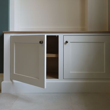 White cabinet with one door open revealing empty shelves.