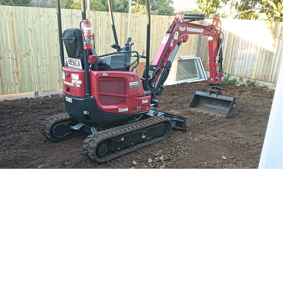 Red Yanmar mini excavator parked on freshly dug soil in backyard.