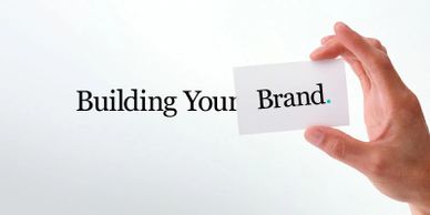 Words  "Building Your Brand" A hand holds a card with the word "Brand." to Podcasts builds brands.