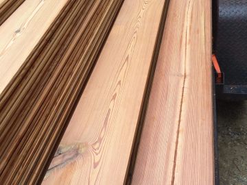 Stack of smooth wooden planks with natural grain patterns.