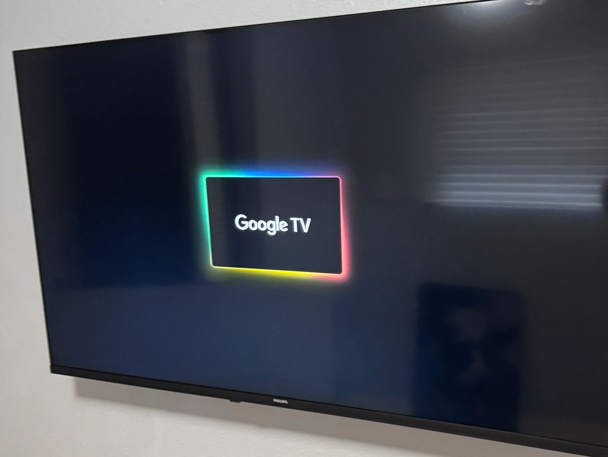 Smart tv mounted to wall with full motion mount.