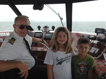 Children with Captain on boat bridge