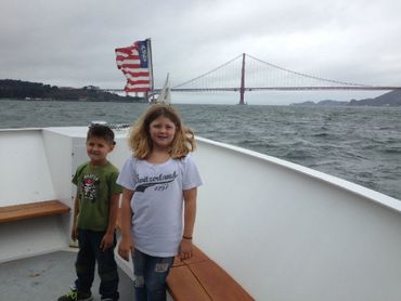 Children on boat with Bay Bridge in background