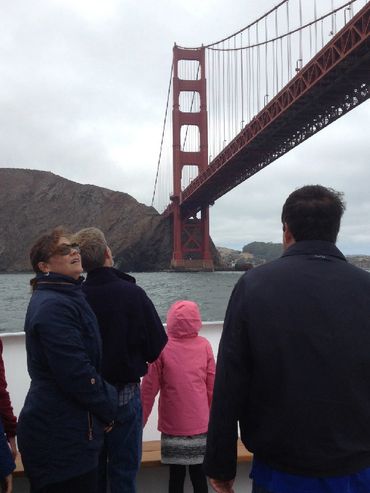 People on boat under the Golden Gate Bridge