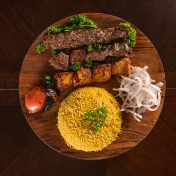 Caroun Mix
Three mixed skewers of chicken tikka, beef tikka, and beef kebab. Served on a bed of pars