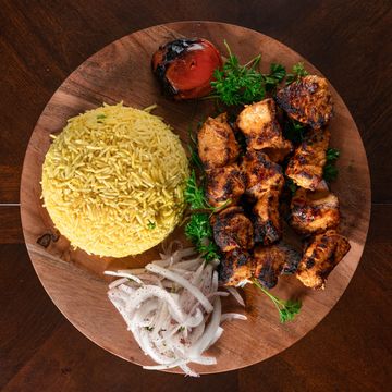 Chicken Tikka
Three deliciously marinated chicken skewers cooked over charcoal. Served on a bed of p