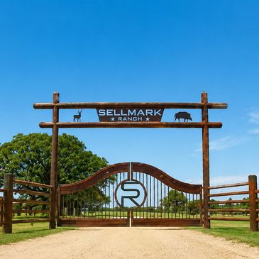 Wooden entrance gate to Sellmark Ranch on a sunny day.