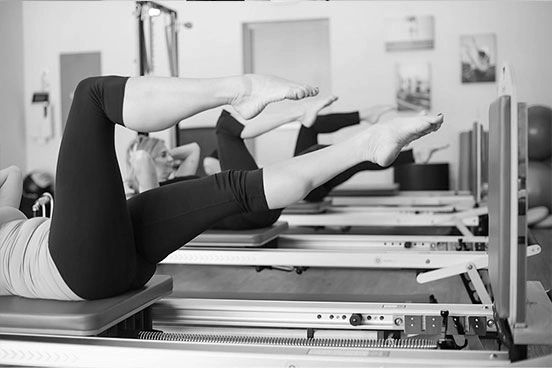 Picture of women working out on Pilates reformer with jumpboards