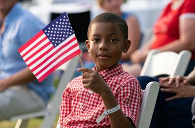 Black boy waving flag on July 4th at White House. Trump, blacks