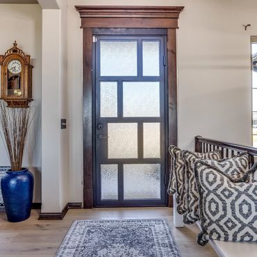 a hinged steel door with obscured glass