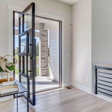 an inside view of an open modern design steel pivot door