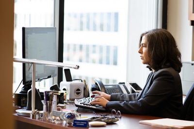 Los Angeles employment law mediator Gail Glick typing at her desk