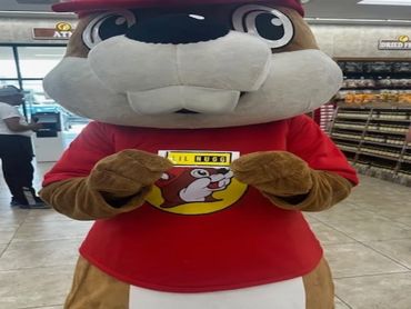 Buc-ee's mascot in store holding a Lil Nugg sticker.