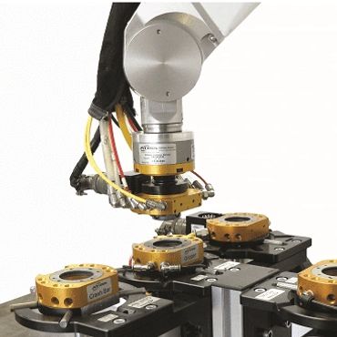 Robotic arm assembling or inspecting mechanical parts on a precision fixture.