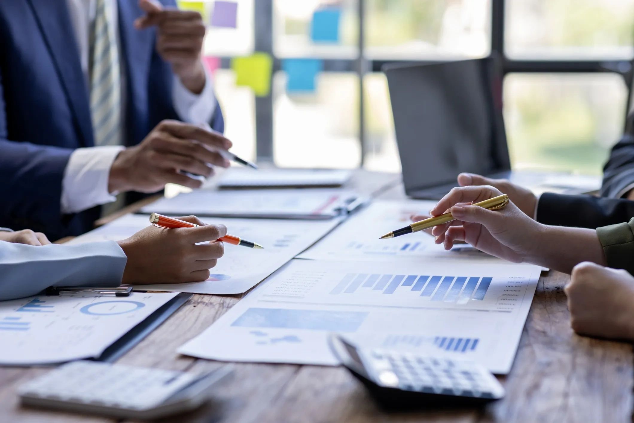 Business team discussing financial charts and data at a meeting.