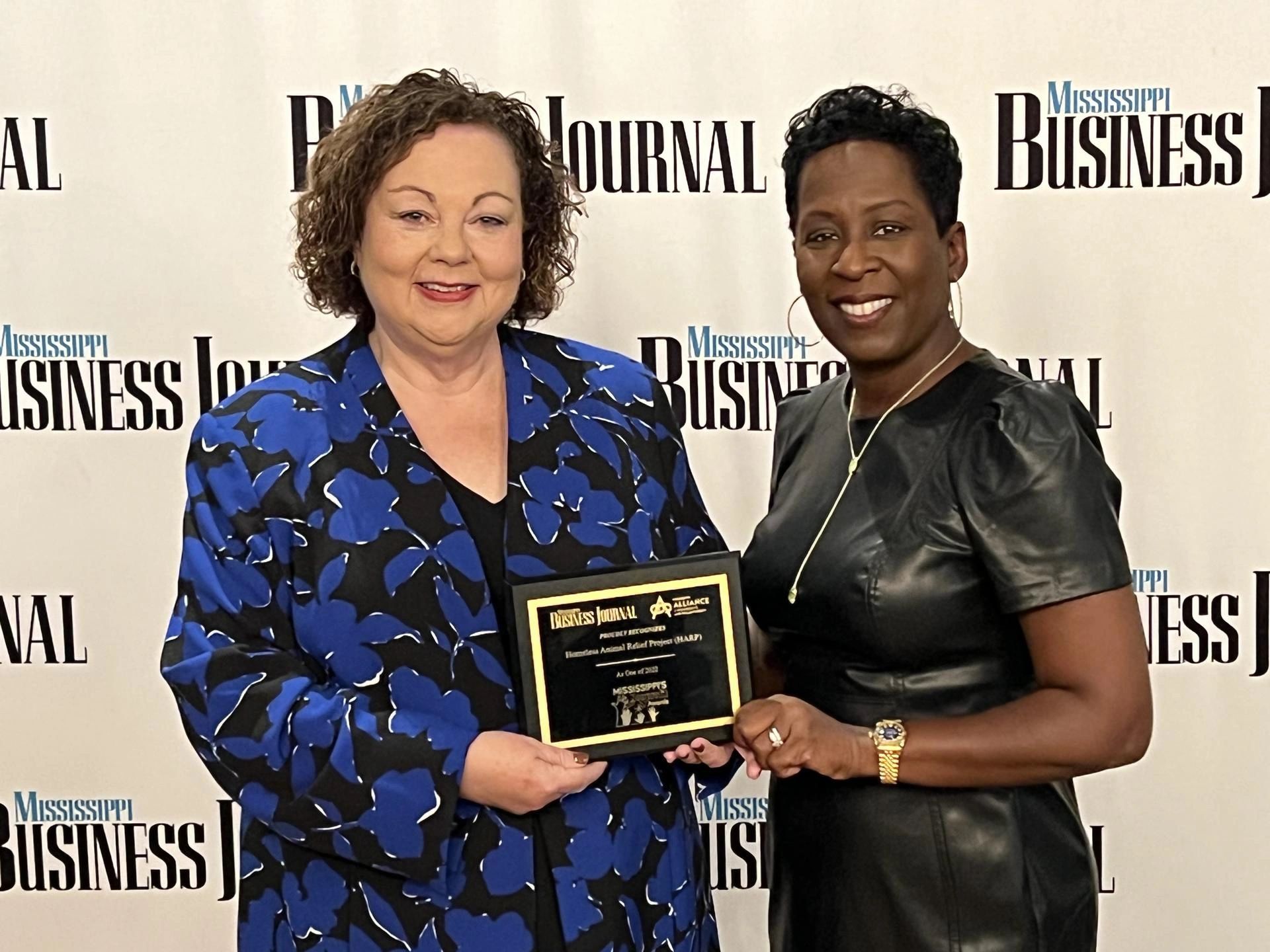 Denise Bynum accepts award for Homeless Animals Relief Project as one of the top 30 nonprofits in MS