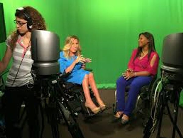 Johileny (manual wheelchair) and Katia (manual wheelchair) in front green screen and microphones.