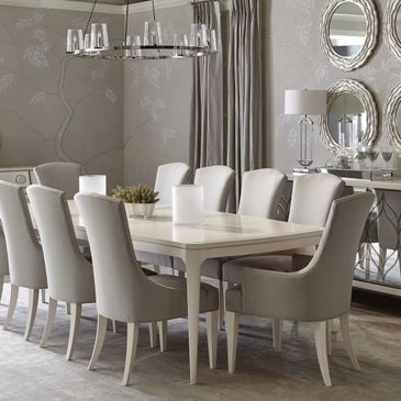 Elegant dining room with beige chairs and a rectangular white table.