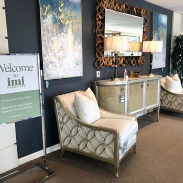 Elegant living room setup with decorative chairs, a console table, and a large mirror.