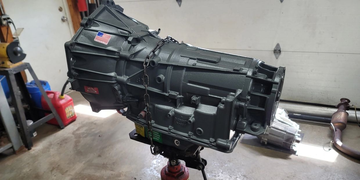 Transmission replacement service at Freedom Automotive showing new transmission with American Flag e