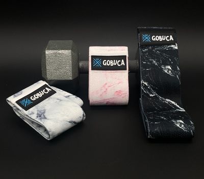 Gobuca Marble Print Hip Bands displayed over a dumbbell.