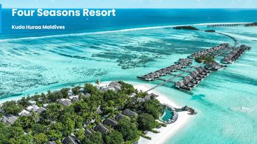 Aerial view of Four Seasons Resort in Maldives with overwater villas and turquoise waters.